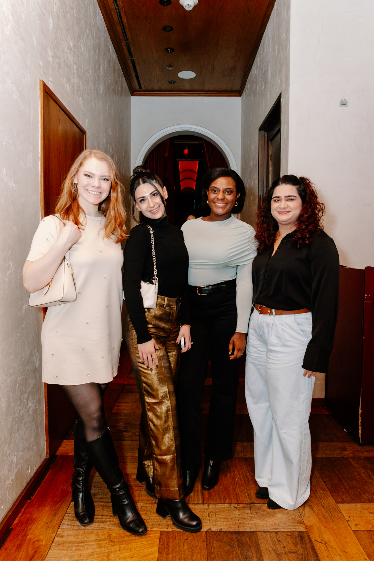Four Her Workplace members smiling together at a member event