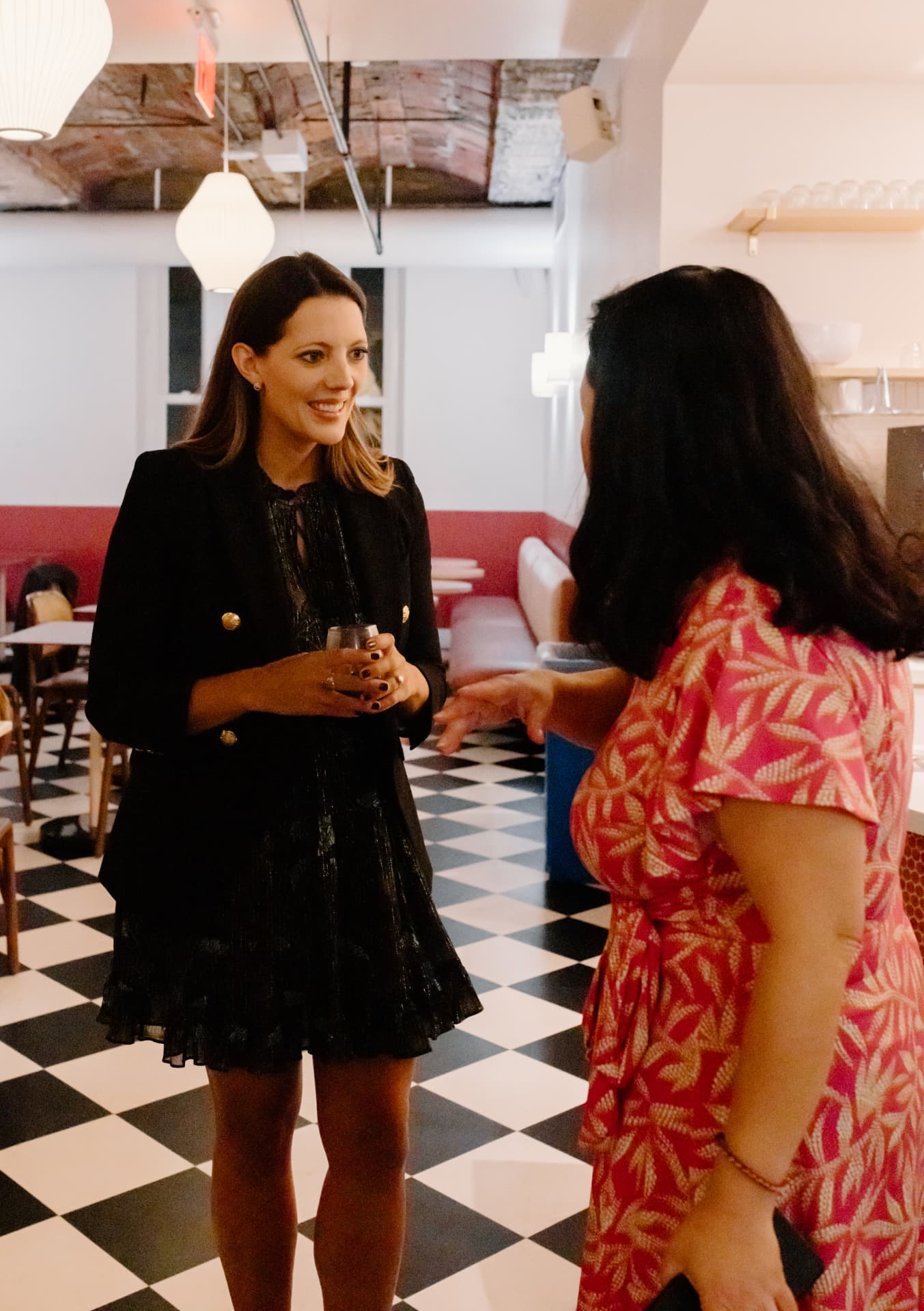 Two Her Workplace members connecting at a private networking event